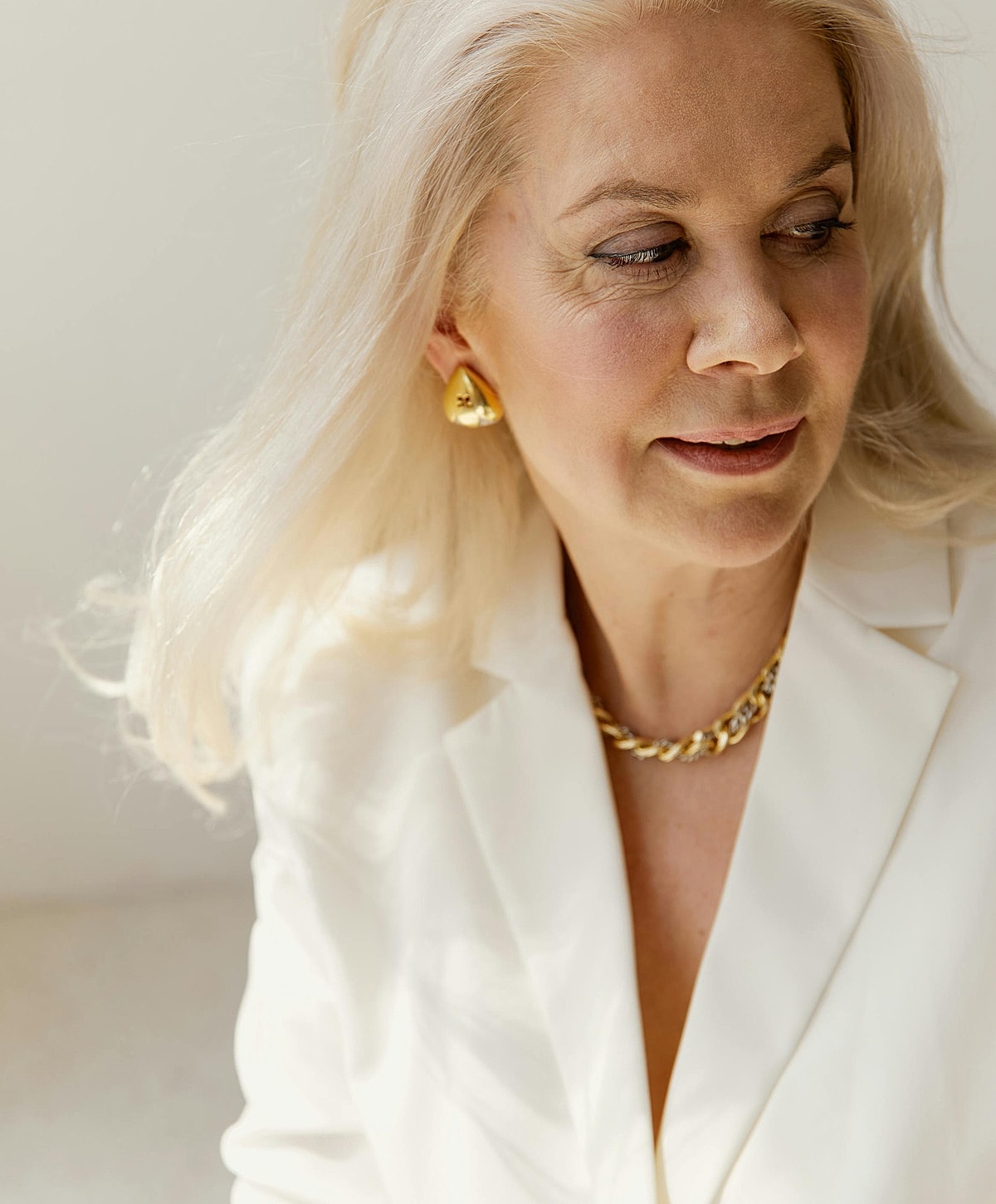 Woman in elegant attire with stylish accessories.