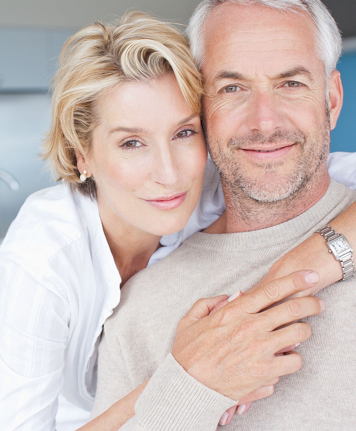 Couple posing together, smiling warmly at camera.